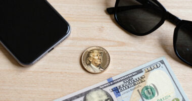 Trump’s face appears on $1 coin and his signature on the $100 bill as his team challenges the law